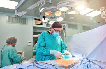 surgeon in the operating room performs the operation