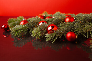 Christmas festive background with coniferous branches and Christmas balls