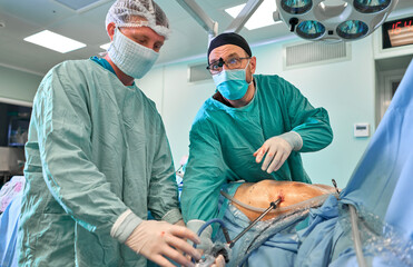 surgeon in the operating room performs the operation