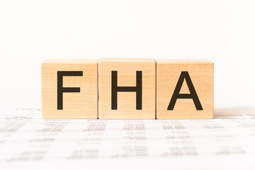 Word fha. Wooden small cubes with letters isolated on white background with copy space available.Business Concept image.