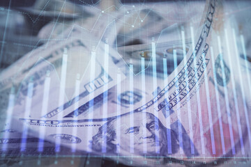Double exposure of forex graph drawing over us dollars bill background. Concept of financial markets.