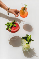 Popular bar summer ice alcoholic cocktails. Gin-tonic, Aperol Spritz and strawberry basil Margarita...