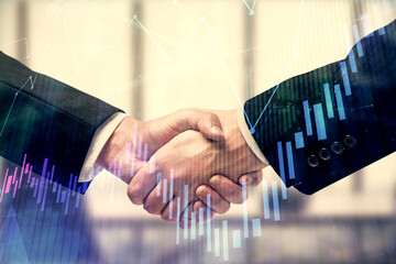 Double exposure of forex graph hologram and handshake of two men. Stock market concept.