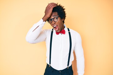 Handsome african american man with afro hair wearing hipster elegant look surprised with hand on head for mistake, remember error. forgot, bad memory concept.