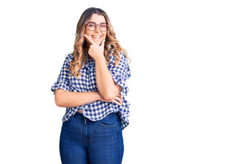 Young caucasian woman wearing casual clothes looking confident at the camera smiling with crossed arms and hand raised on chin. thinking positive.