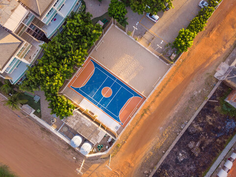 Aerial view of basketball and multi sport ground and street in a neighbourhood close to Aquiraz in Brazil.