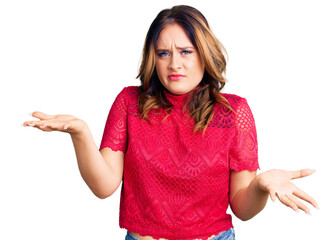 Young beautiful caucasian woman wearing casual clothes clueless and confused expression with arms...