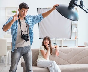 Young photographer working in photo studio