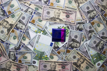 Condom lies on the background of money dollars.