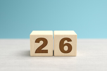 Wooden toy blocks forming the number 26.