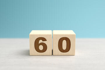 Wooden toy blocks forming the number 60.