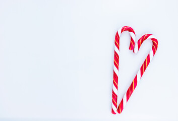Candy cane in the shape of the heart with white space for text.