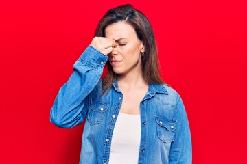 Young beautiful woman wearing casual clothes tired rubbing nose and eyes feeling fatigue and headache. stress and frustration concept.