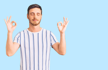 Handsome young man with bear wearing casual clothes relax and smiling with eyes closed doing meditation gesture with fingers. yoga concept.
