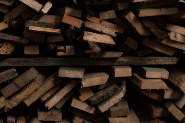 Firewood from boards is stacked neatly. Firewood rack. Timber trimming.