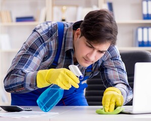 Cleaner man cleaning the office