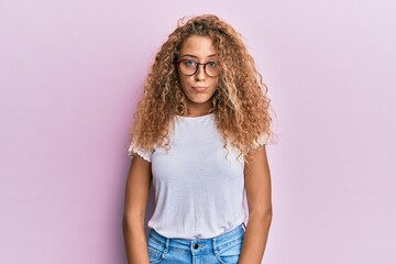 Beautiful caucasian teenager girl wearing white t-shirt over pink background depressed and worry for distress, crying angry and afraid. sad expression.