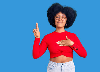 Young african american girl wearing casual clothes and glasses smiling swearing with hand on chest...