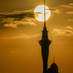 sky city tower of new zealand and the sun in a beautiful evening