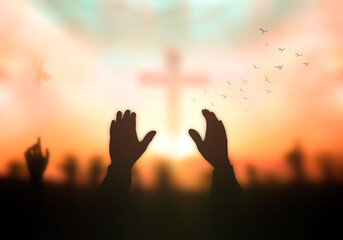 Resurrection of Easter Sunday concept: Silhouette christian people hand rising over blurred cross on spiritual light background - obrazy, fototapety, plakaty