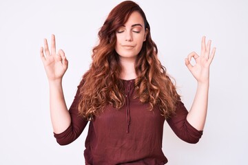 Young beautiful woman wearing casual clothes relax and smiling with eyes closed doing meditation gesture with fingers. yoga concept.