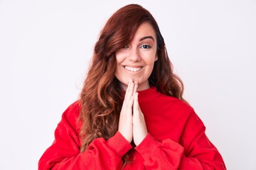 Young beautiful woman wearing casual clothes praying with hands together asking for forgiveness smiling confident.