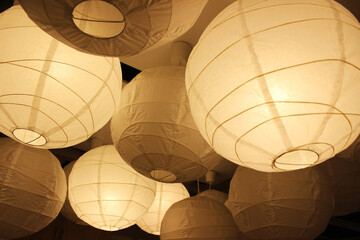 Many round paper lamps hung up