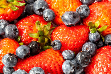 Bluieberries and strawberries in cup