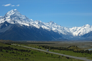 lonely camper van driving on road in hooker valley through Aoraki Mount Cook National Park, Canterbury, Neuseeland