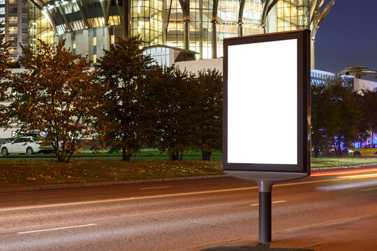 Vertical Blank Billboard In The City By The Road, Evening City. Mock-up.