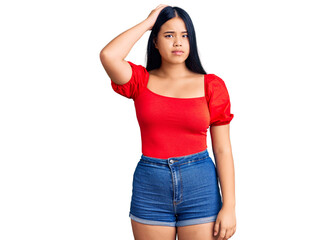 Fototapeta premium Young beautiful asian girl wearing casual clothes confuse and wonder about question. uncertain with doubt, thinking with hand on head. pensive concept.