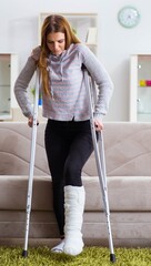 Young woman with broken leg at home