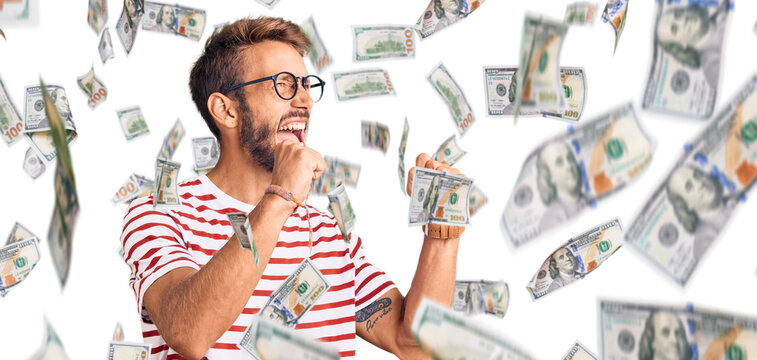 Handsome blond man with beard wearing casual clothes and glasses shouting angry out loud with hands over mouth