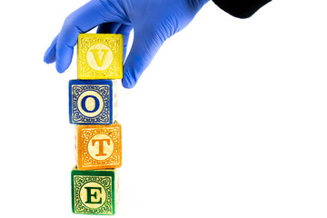 Gloved Hand with Wooden Blocks Spell Vote