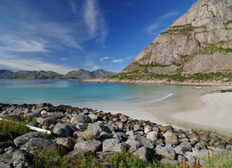 Fototapeta premium Wild Rorvik Beach With Turquoise Water On Lofoten Island Austvagoy On A Sunny Summer Day With A Clear Blue Sky And A Few Clouds