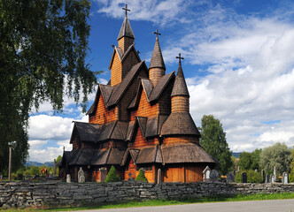 Fototapeta na wymiar View To The Largest Stave Church Of Norway In Heddal On A Sunny Summer Day With A Clear Blue Sky And A Few Clouds