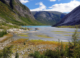 View To Lake Nigardsbrevatnet At The Glacier Nigardsbreen In Jostedalsbreen National Park On A Sunny Summer Day With A Clear Blue Sky And A Few Clouds