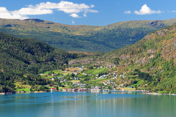 View From Urnes To The Lustrafjord And The Village Solvorn On A Sunny Summer Day With A Clear Blue Sky And A Few Clouds