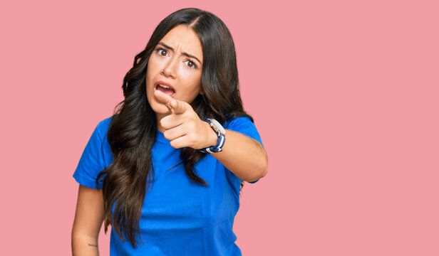 Beautiful brunette young woman wearing casual clothes pointing displeased and frustrated to the camera, angry and furious with you