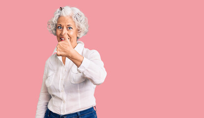 Senior grey-haired woman wearing casual clothes doing happy thumbs up gesture with hand. approving expression looking at the camera showing success.