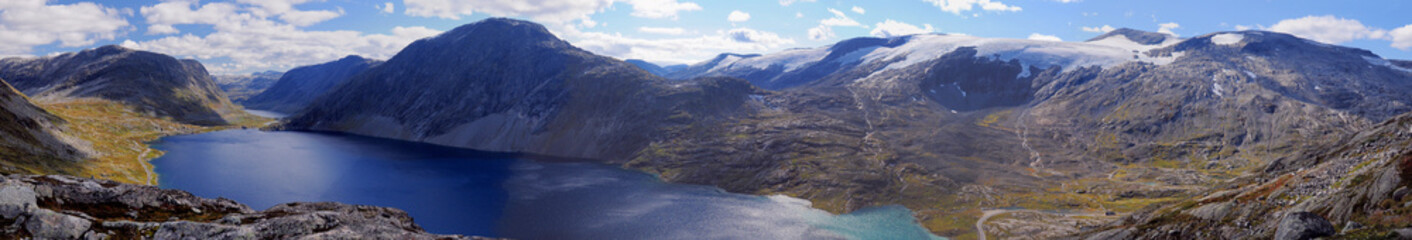 Panorama View To The Lake Djupvatnet In The Barren Landscape On The Way To Dalsnibba Near Geiranger On A Sunny Summer Day With A Clear Blue Sky And A Few Clouds