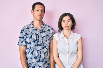 Beautiful couple wearing casual clothes looking sleepy and tired, exhausted for fatigue and hangover, lazy eyes in the morning.