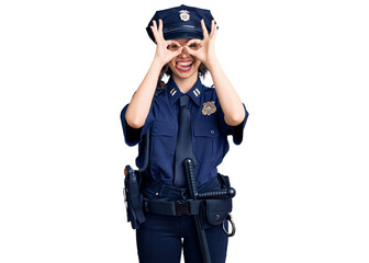 Young beautiful girl wearing police uniform doing ok gesture like binoculars sticking tongue out, eyes looking through fingers. crazy expression.