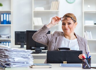 Businesswoman very busy with ongoing paperwork