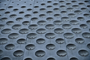 An abstract concrete surface with circular textured pattern.