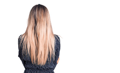 Young beautiful blonde woman wearing casual clothes standing backwards looking away with crossed...