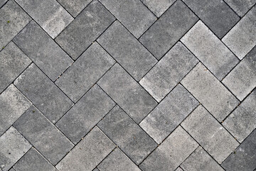 Pavement laid in hashed concrete blocks pattern.