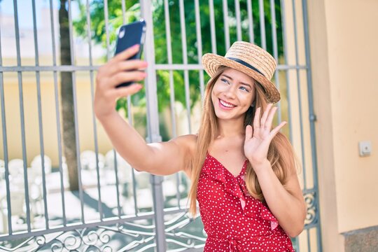Young caucasian tourist girl smiling happy doing video call using smartphone at the city.