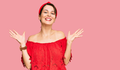 Young brunette woman with short hair wearing casual summer clothes and diadem celebrating crazy and...