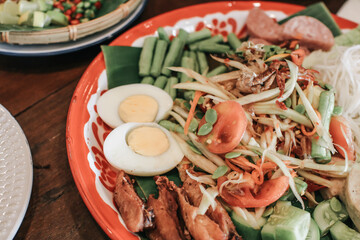 Thai food concept. Mixed Som tum or Mixed papaya salad with variety of side dishes in a large tray. Hot and Spicy Thai food.